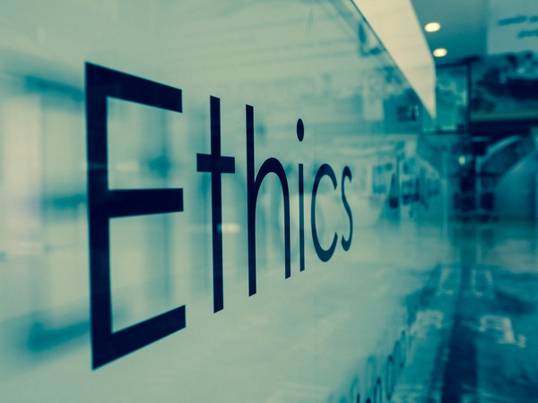 A plastic sign on a wall saying 'Ethics'