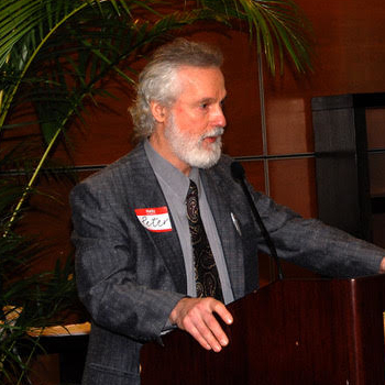 Peter standing at lectern presenting